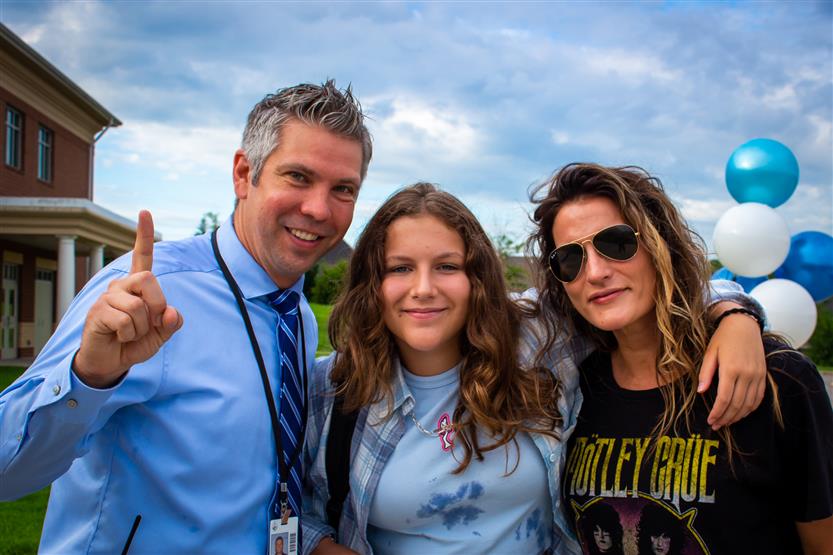 Administrators and staff smile